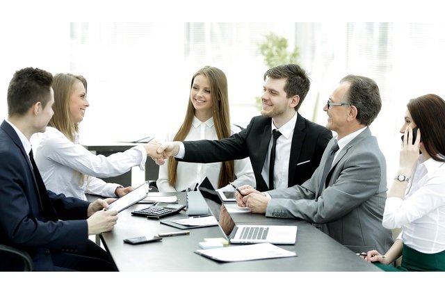 welcome handshake of business partners at the negotiating table